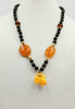 "Sweet Forgotten Fang." Whidby jet, Baltic amber, adjustable 14KYG, & antique Scottish amber pendant. 24" to 27" length.