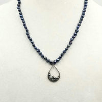 Classic. Vividly dyed black pearl necklace on black silk with sterling marcasite pendant.