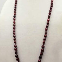 Past Work. A rope necklace 35" long is made of graduated cranberry dyed pearls & rubies on hand-knotted red silk. SOLD.