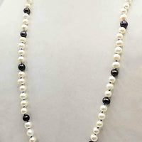 Classic & beautiful, yet modern.  Black & peacock pearl rope necklace hand-knotted with periwinkle silk. 35" length.