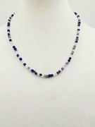 Field of Blue Bonnets. 14KYG, iolite, lapis, azuremalachite, moonstone, labradorite and jadeite necklace on purple silk.