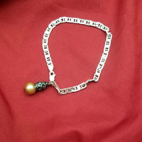 Sterling silver marine link and pink freshwater pearl charm bracelet.