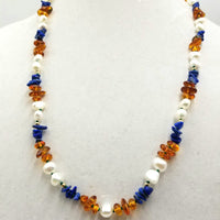 Baltic Solstice, a matinee length necklace of Baltic amber, lapis, and pearls with 14kyg on green silk