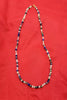 Field of Blue Bonnets. 14KYG, iolite, lapis, azuremalachite, moonstone, labradorite and jadeite necklace on purple silk.