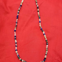 Field of Blue Bonnets. 14KYG, iolite, lapis, azuremalachite, moonstone, labradorite and jadeite necklace on purple silk.