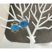 Vibrant silvertone and druzy dangle earrings with sterling silver hooks.