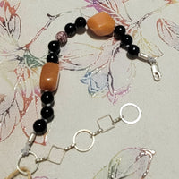 Adjustable sterling silver, onyx, orange aventurine, and jasper bracelet on silk, so luxe!