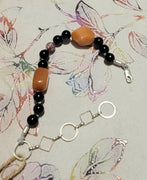 Adjustable sterling silver, onyx, orange aventurine, and jasper bracelet on silk, so luxe!