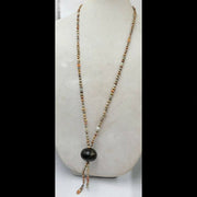 Golden pearl, jadeite, nephrite, and quartz XL X form necklace.