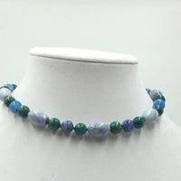 Bold Malachite, sodalite, marble, and crackle agate sterling silver choker on green silk.