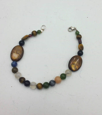 Multi-stone, shell, tiger's eye, garnet, nephrite, sterling bracelet.
