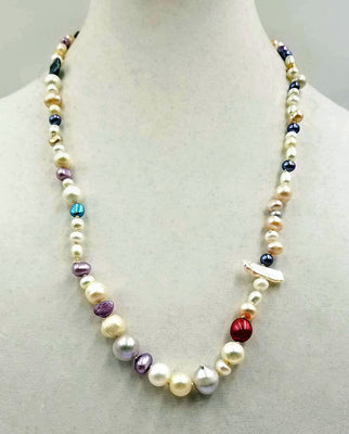 Short rope of multi-color Baroque pearls, hand-knotted on beige silk.