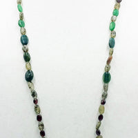 Rope of garnets, amethyst, moss agate, chrysoprase, & fluorite on white silk.