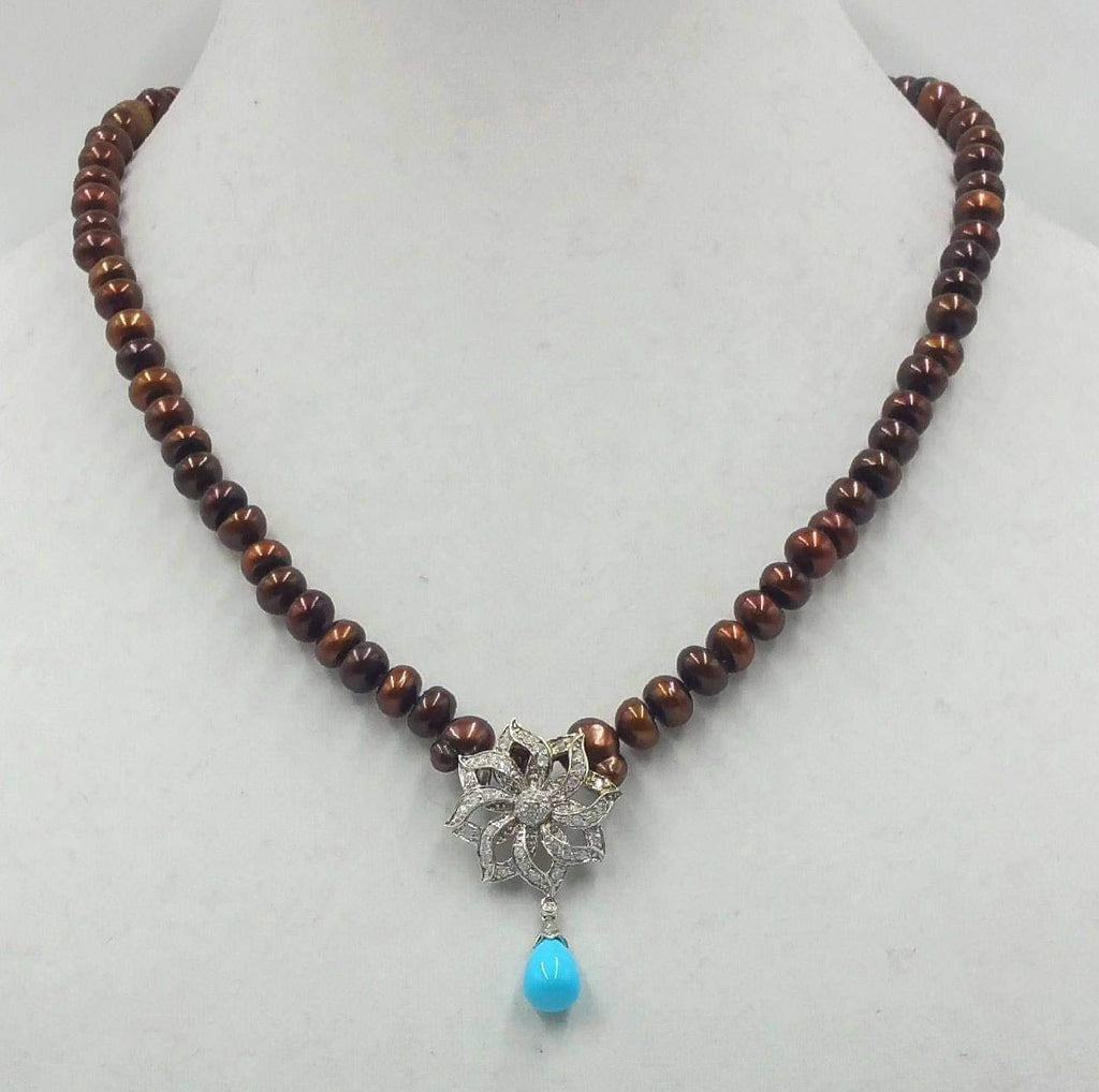 Get your sunglasses. This amazing necklace is blinding.  14KWG, bronze pearl necklace with 14KWG .72ct diamond & turquoise pendant on hand-knotted purple silk. 19.50" Length.