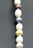 Opera length. Fine, multi-color, pearls, individually knotted on grey silk with 14KYG clasp.