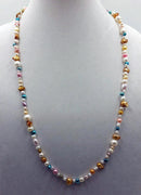 Opera length 32", multi-color, Baroque pearl necklace, adjustable sterling silver clasp. Master hand-knotting with purple silk.