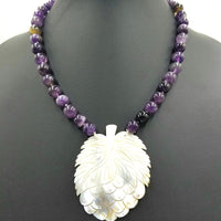 Unusual carved mother of pearl  pendant on amethyst necklace.