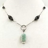 Jadeite pendant on a sterling silver and onyx necklace. Vegan.