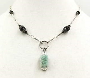 Jadeite pendant on a sterling silver and onyx necklace. Vegan.