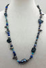 Black, blue, silver pearls, sodalite, turquoise with sterling silver accents.  26" Opera length.