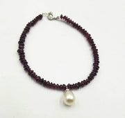 Adjustable sterling silver, garnet bracelet with glass pearl focal. Vegan.