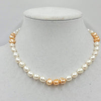 2-tone pearl choker with sterling silver clasp and accents on beige silk. 17in length.