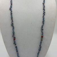 Multi-tone peacock pearl necklace on navy silk. 41" rope length