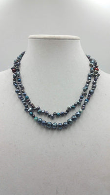 Multi-tone peacock pearl necklace on navy silk. 41