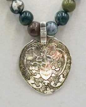 Vintage. Bat pendant of sterling silver on strand of agates on purple silk. Adjustable clasp.
