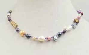 Multicolor baroque pearl and amethyst necklace hand knotted on purple silk with sterling toggle clasp. 17.25" Princess length.