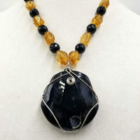 Bold calcite, onyx, & tiger's eye pendant on sterling silver necklace.