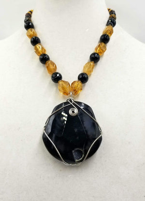 Bold calcite, onyx, & tiger's eye pendant on sterling silver necklace.