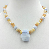 Precious yellow jadeite, & blue lace agate on pale pink silk with vintage sterling silver clasp. 18" Length.