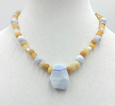 Precious yellow jadeite, & blue lace agate on pale pink silk with vintage sterling silver clasp. 18