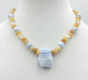 Precious yellow jadeite, & blue lace agate on pale pink silk with vintage sterling silver clasp. 18" Length.