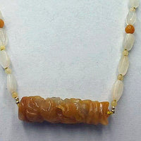 Precious yellow & orange jadeite, moonstone, & 14KYG necklace on bright yellow silk.