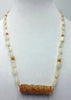 Precious yellow & orange jadeite, moonstone, & 14KYG necklace on bright yellow silk.