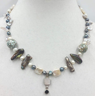 Multi-tone pearl, shell, onyx & sterling silver pendant necklace on black silk.