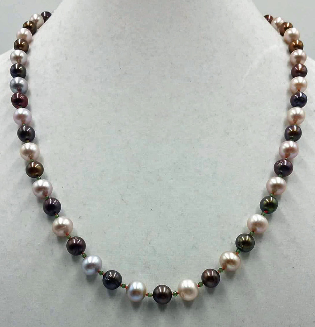 Bi-tone pearls, faceted jadeite, and 14KYG on crimson silk.