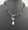 Vintage Nevada turquoise, bi-tone pearl, sterling toggle necklace on purple silk.
