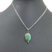 Turquoise-dyed howlite pendant on a sterling silver chain. SOLD