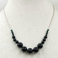 Graduated Black onyx & sterling silver necklace on verde silk.