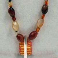 Sterling silver, carnelian, & flame agate necklace with Murano glass pendant on verde silk. 35" Opera length.
