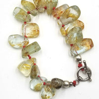 Rutilated Quartz, sterling silver toggle bracelet on scarlet silk.