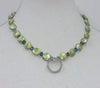 Sterling silver, green pearl, art glass, and CZ pendant necklace on pale silk.