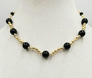 Simply Elegant. Old world charm with a modern twist. Vintage 14K gold & black onyx necklace, hand-knotted with white silk. 16"  Princess Length.