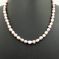Variegated pink Pearls, hand-knotted on silk with 14Kyellow gold clasp and accents.  Necklace. 20.5" Length.