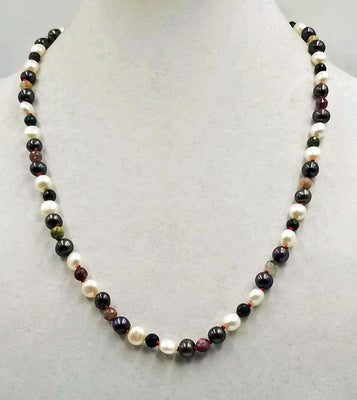 Beautiful pearl & tourmaline necklace, hand-knotted with crimson silk. A 14KWG clasp finishes the look of simple elegance. 24