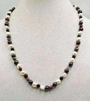 Beautiful pearl & tourmaline necklace, hand-knotted with crimson silk. A 14KWG clasp finishes the look of simple elegance. 24" length.