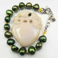 Adjustable sterling silver bracelet, green pearls on golden silk. 5" - 6.75" Length.